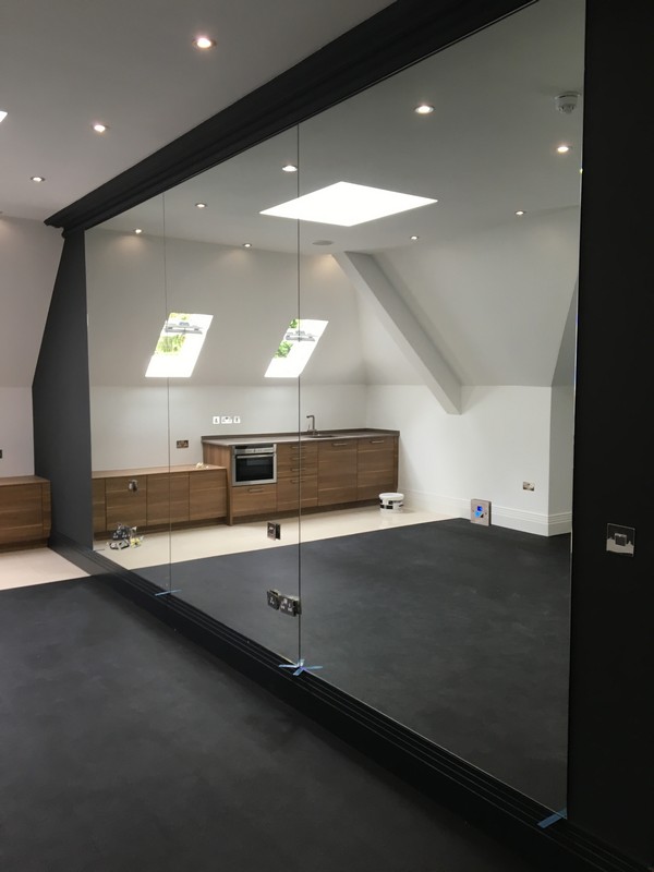 Frameless glass partition in loft conversion by Amersham glaziers