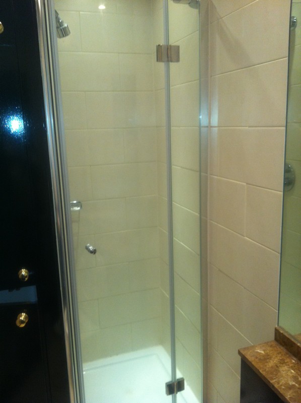Frameless glass shower enclosure with chrome fittings in Amersham