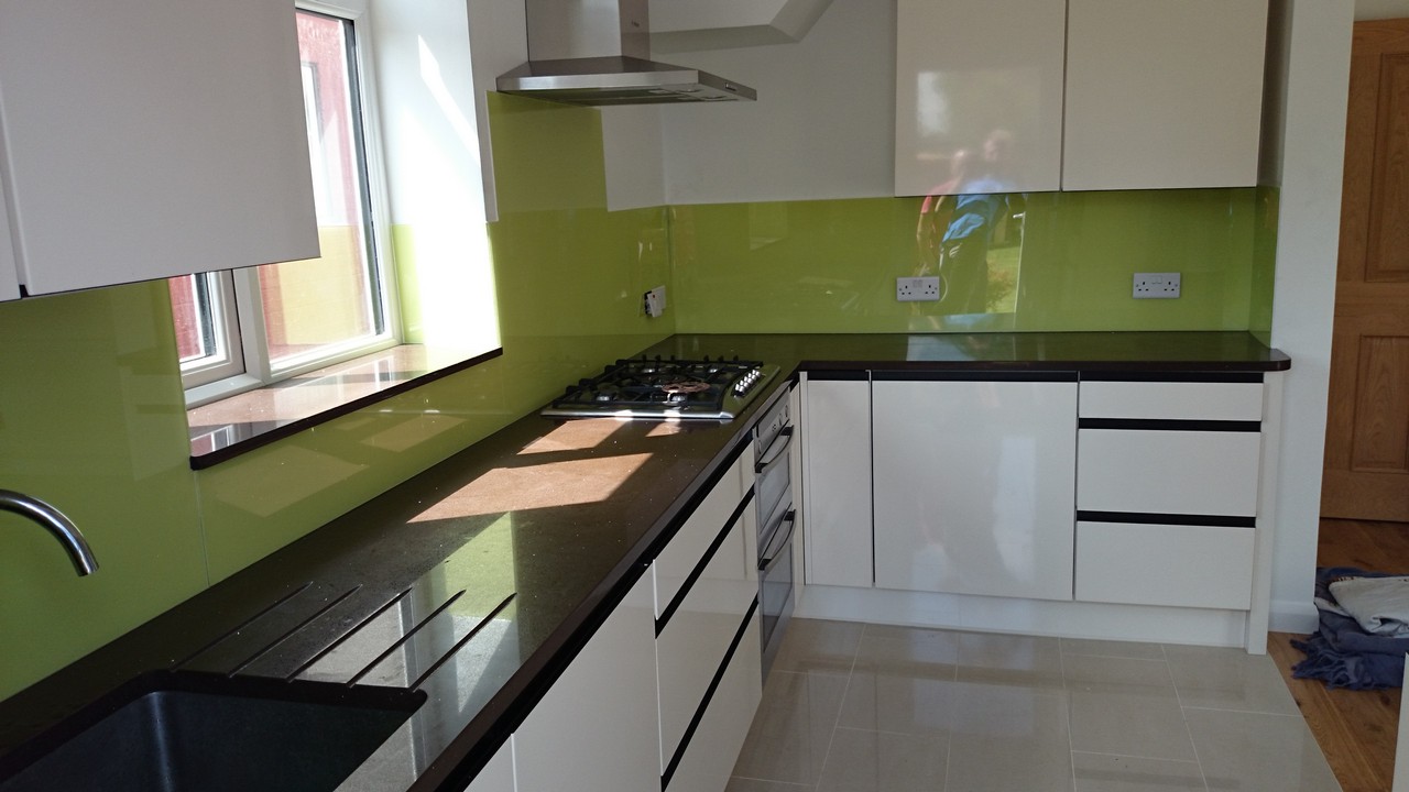 Lime green glass kitchen splashback installed by Amersham glaziers